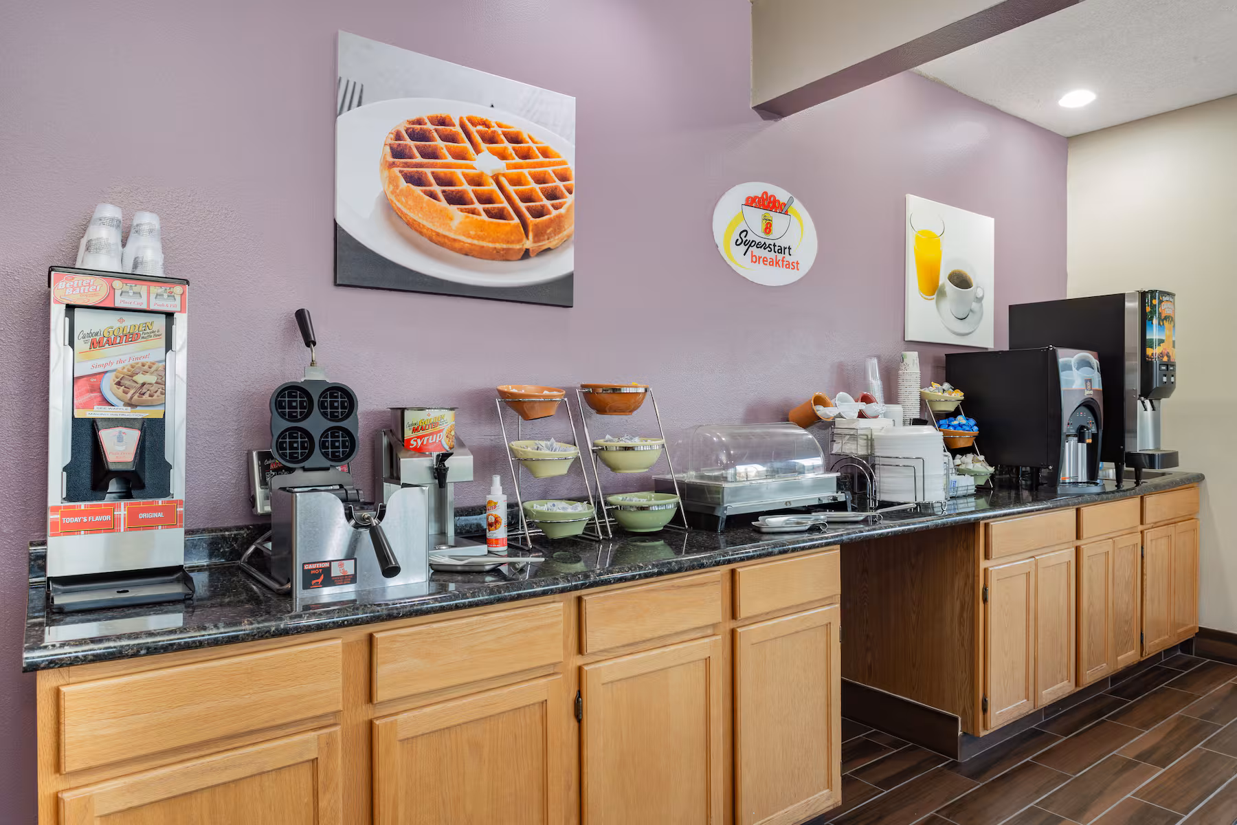 Complimentary breakfast counter with coffee, cereal, and fresh fruit
